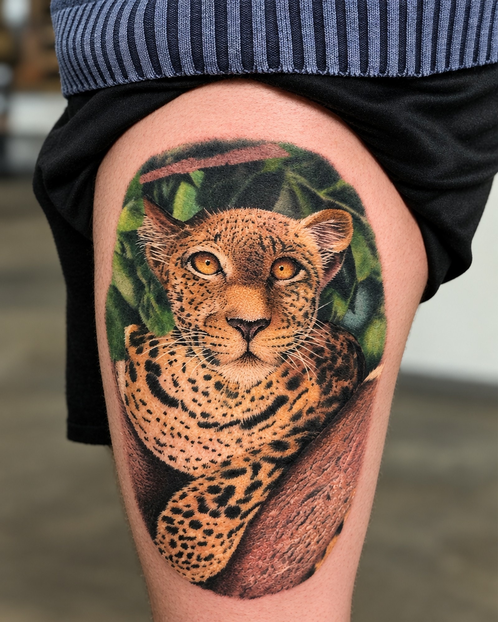Léopard en réalisme couleur sur la cuisse, par Kako Tattoo à Genève